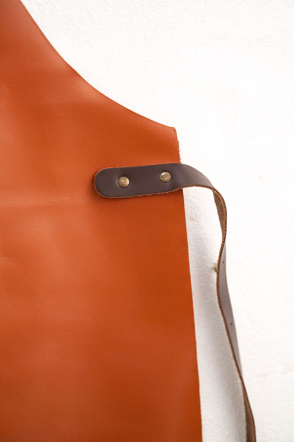 Close-up of CraftLuxe premium cognac leather apron detailing