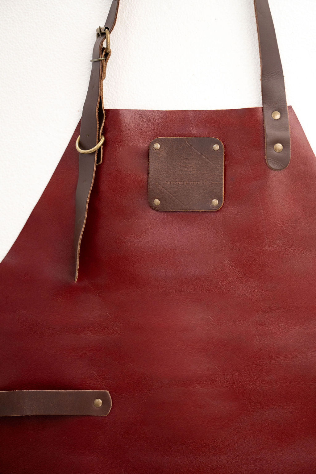 Red leather workshop apron for woodworking and crafts