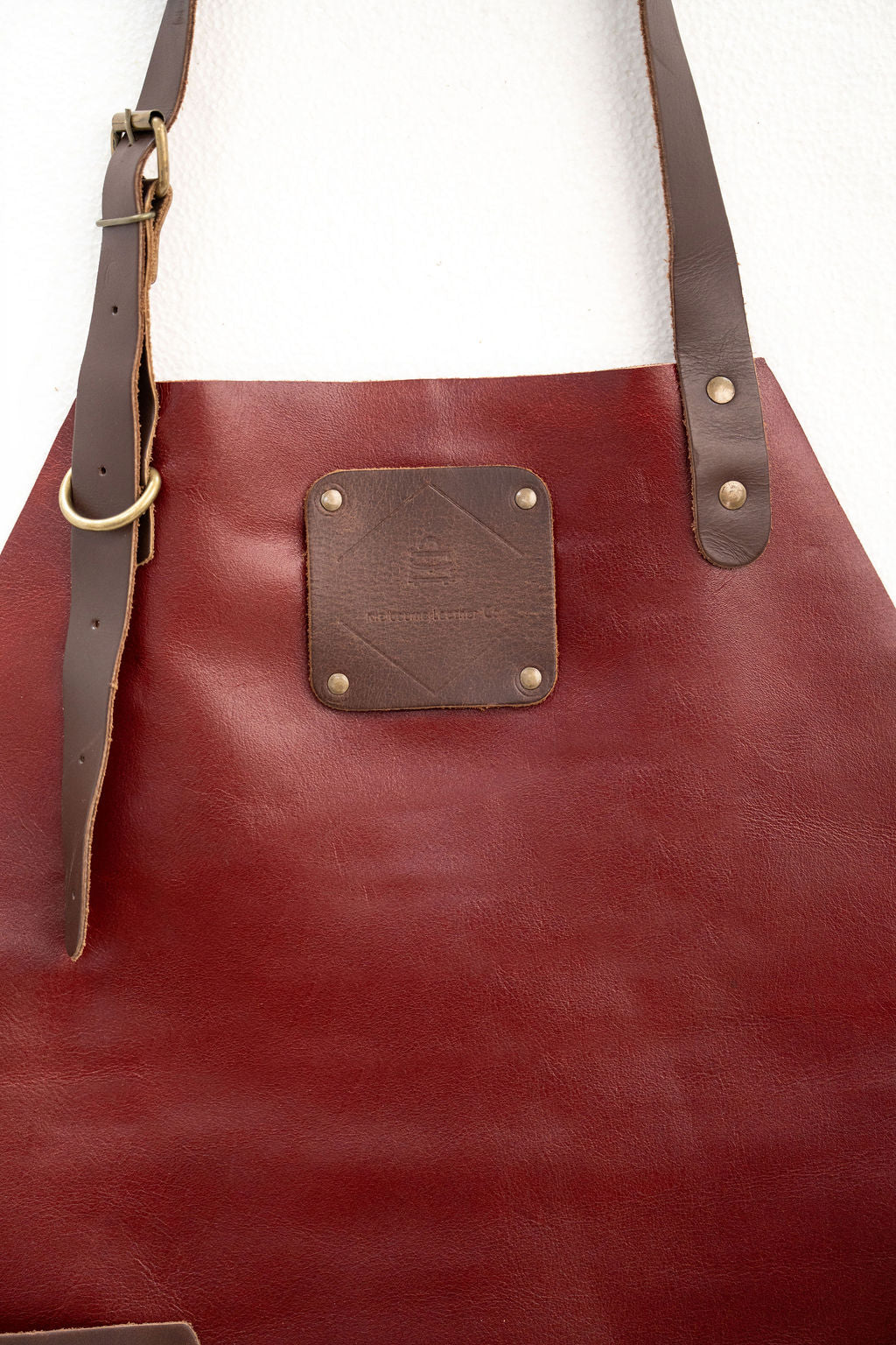 Close-up of CraftLuxe red leather apron detailing