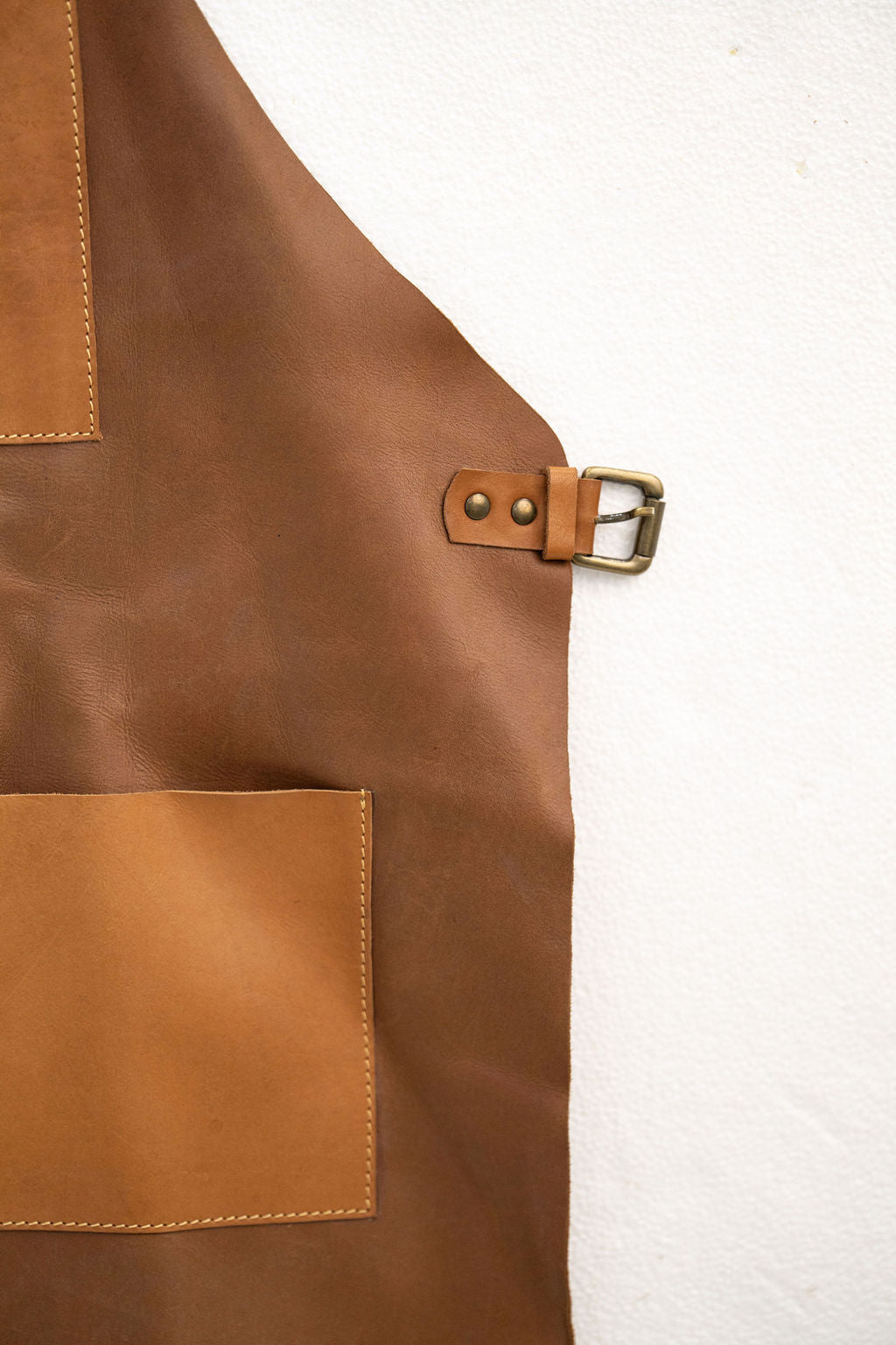 Tan leather workshop apron with functional front pockets