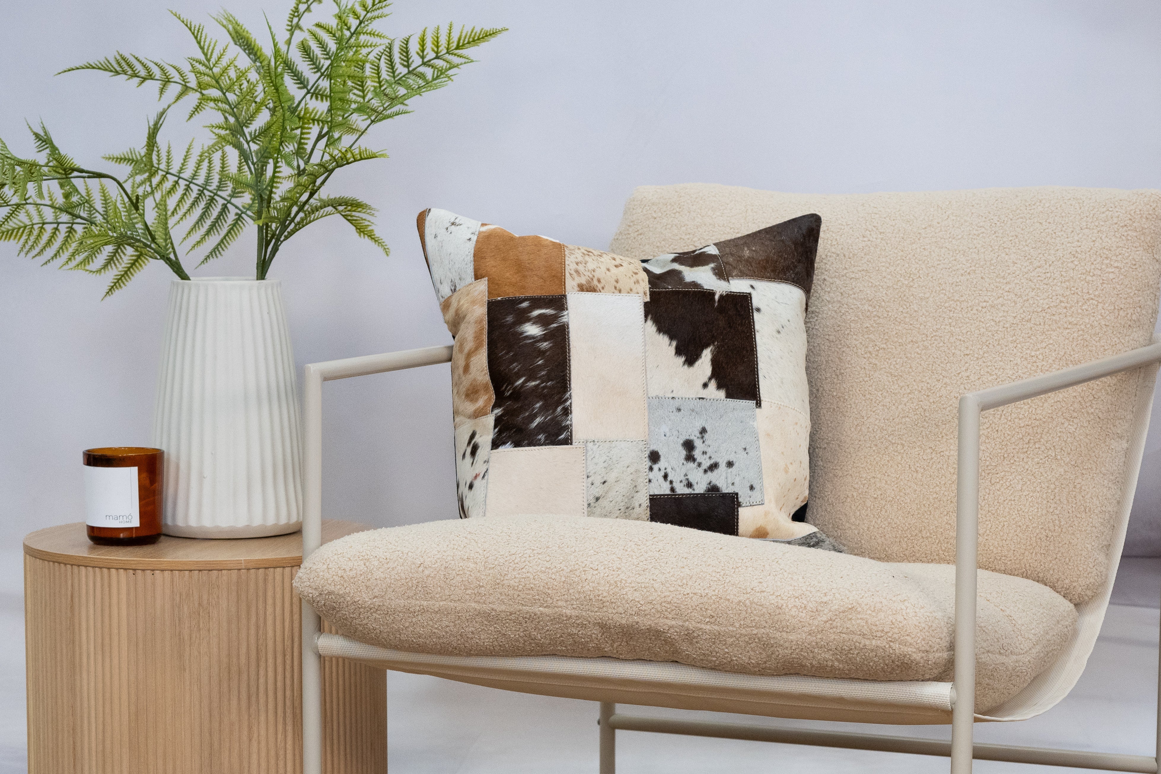 Handcrafted cowhide cushion with rustic patchwork design