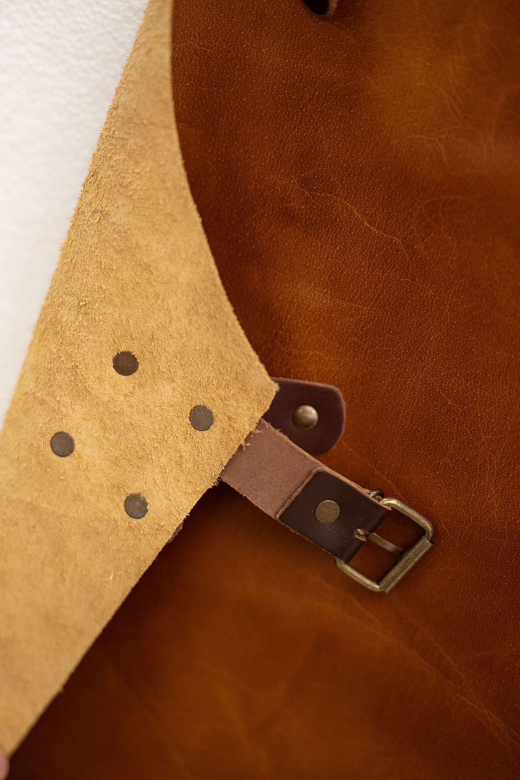 Vintage brown leather work apron for crafts and workshop use