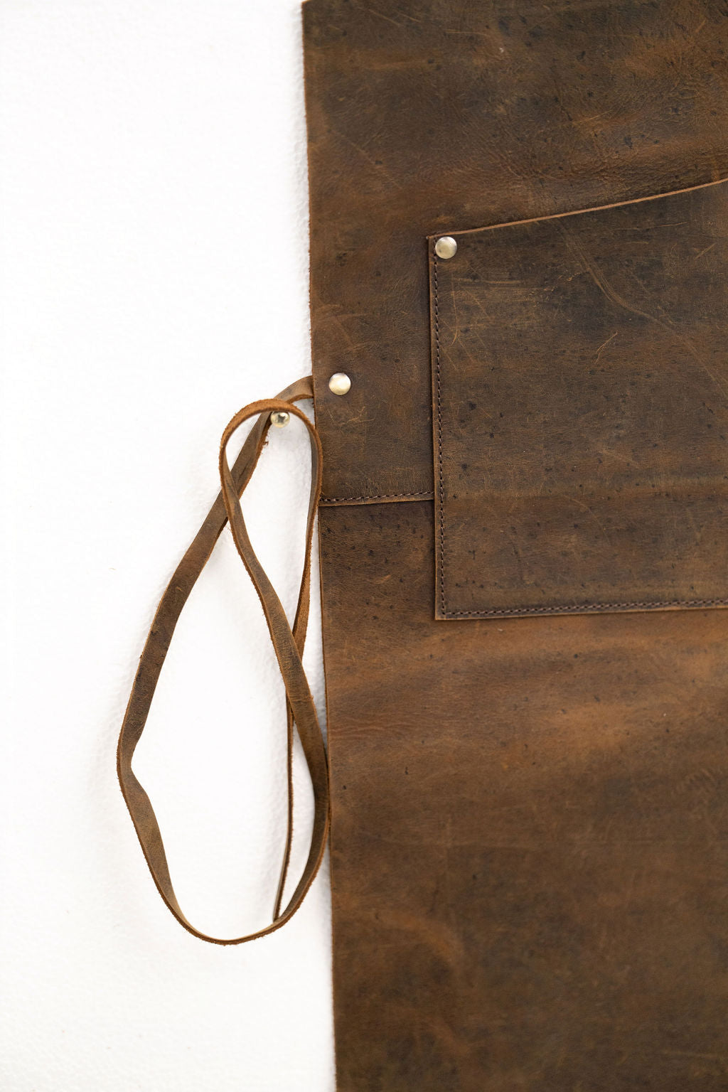 Brown leather apron with multiple utility pockets for makers