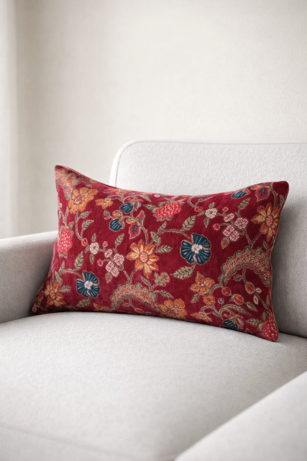 Crimson velvet cushion cover with elegant floral pattern