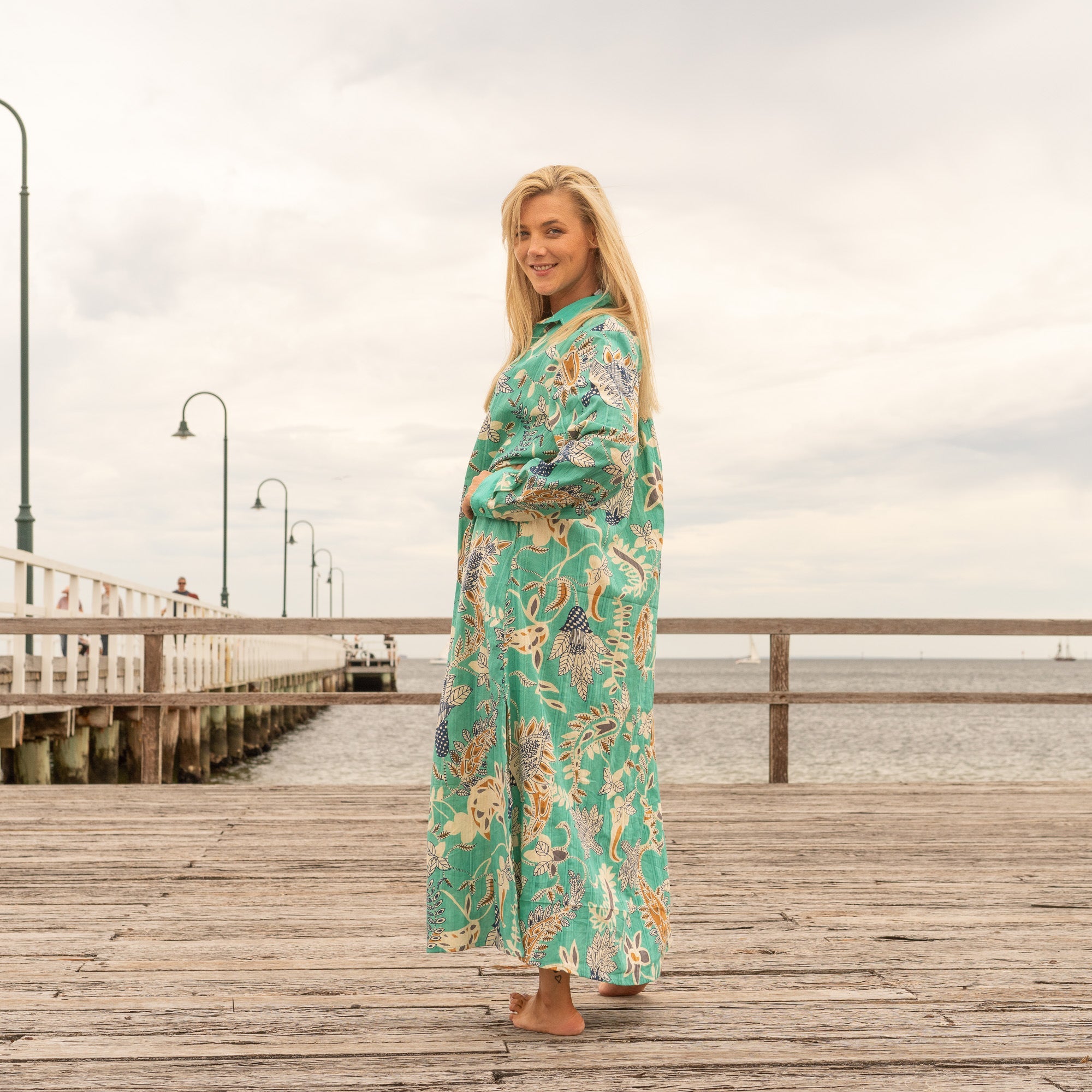 Green cotton shirt dress with bold botanical pattern and flowing fit